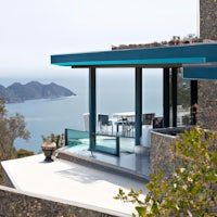 a house on a hill overlooking the ocean